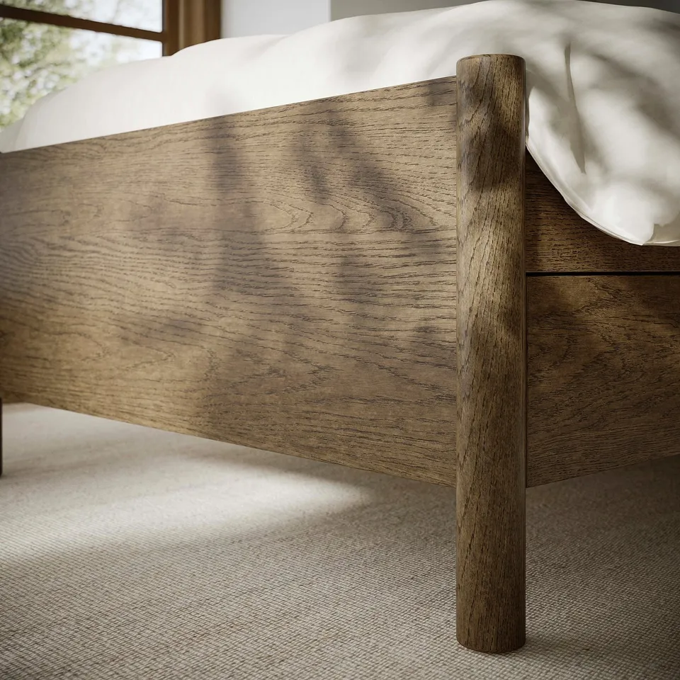 Close-up of TONSTAD bed frame showing smooth, brushed wooden finish and sturdy, rounded legs, emphasising high-quality craftsmanship.