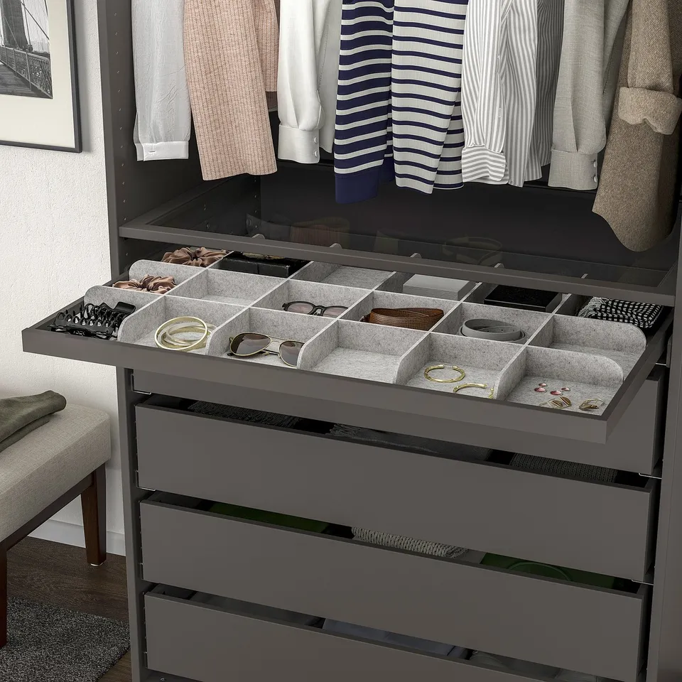 Organised jewellery and accessories in grey felt KOMPLEMENT tray, with 18 compartments, inside a wardrobe.
