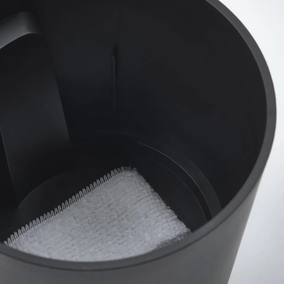 Black self-watering planter with visible water level.