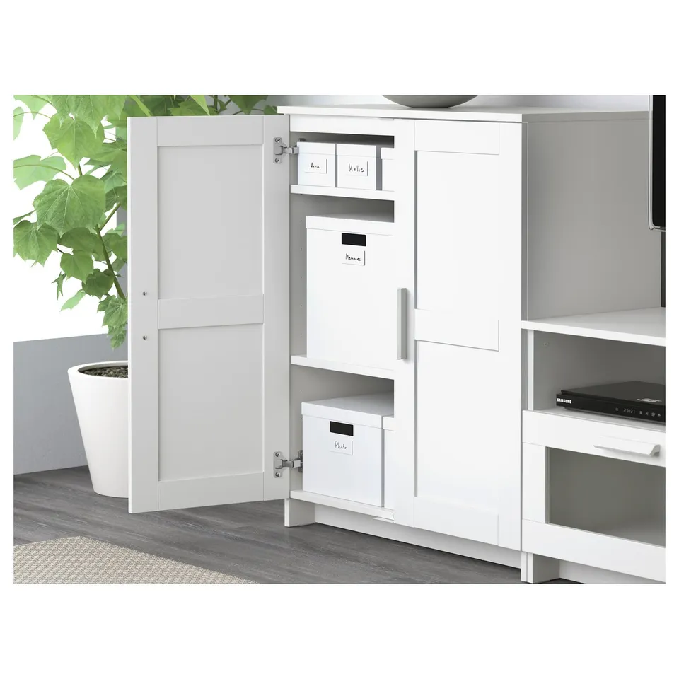 White tv cabinet with adjustable shelves and large drawers, open door in left section.