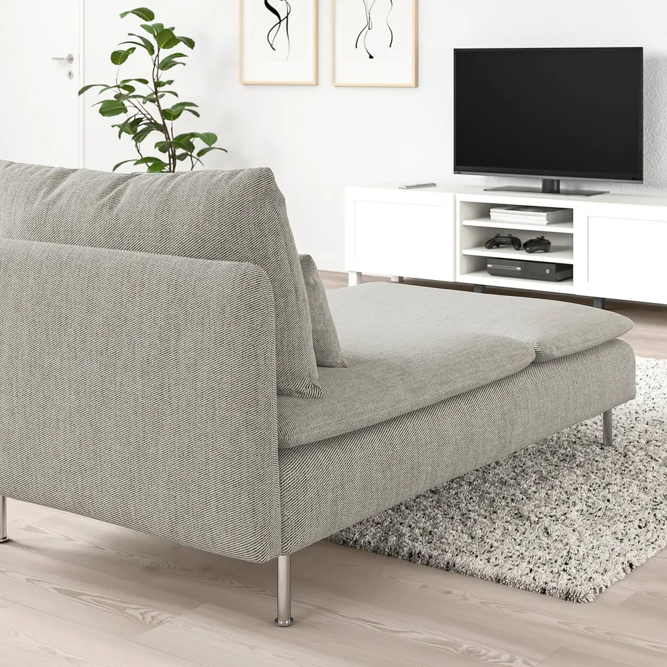 Modern minimalist living room: grey SÖDERHAMN chaise longue, large flat screen tv on stand, white walls, plant, abstract art.