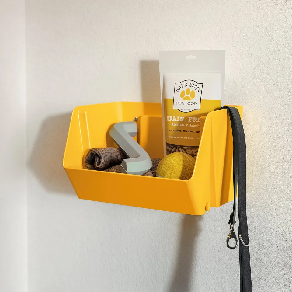 Bright yellow wall-mounted storage bin holding dog treats, leash, and grooming tools.