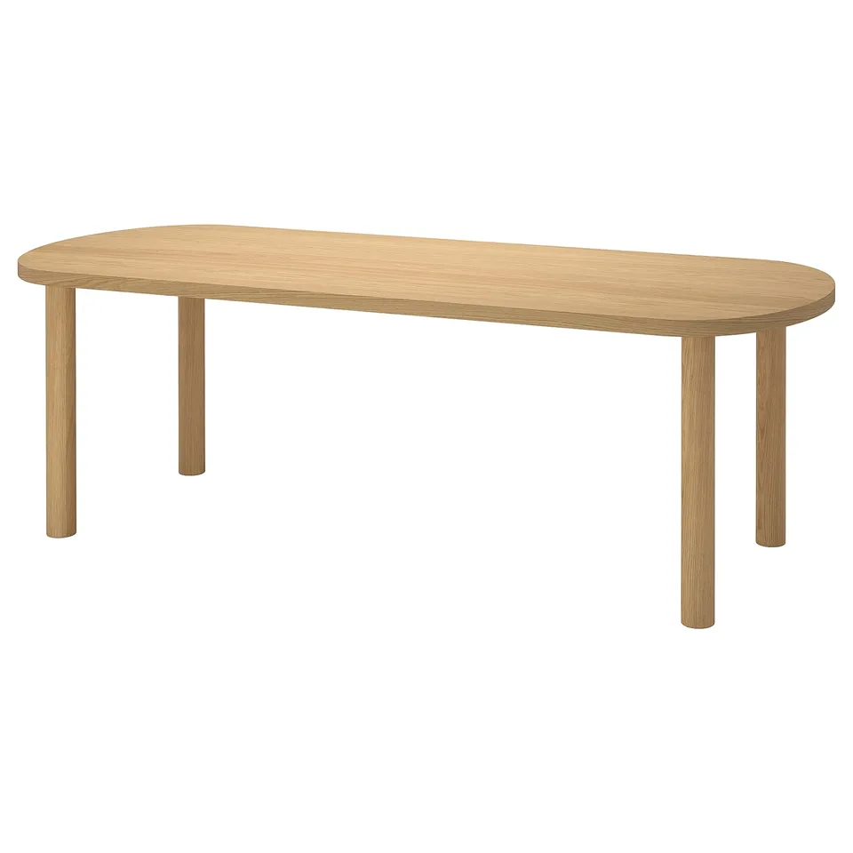 The STOCKHOLM 2025 oval dining table in a light oak colour, showcasing a sleek, natural wood design with a durable finish.