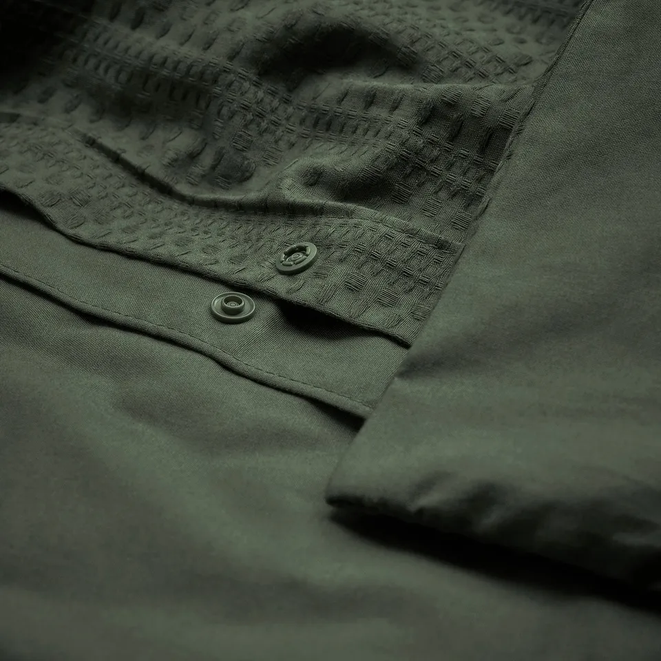 Dark green duvet set with waffle weave, featuring button and press-stud closures.