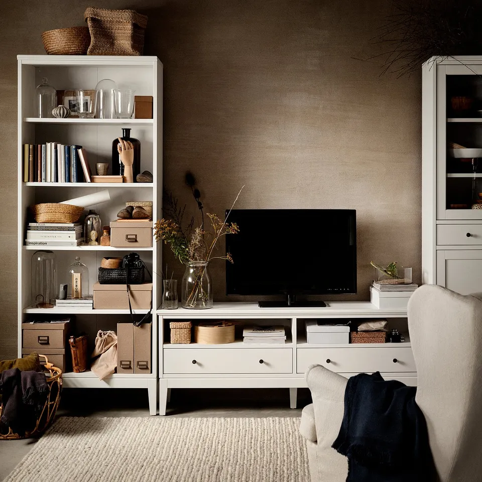 Contemporary living room with IDANÄS tv bench, flat screen, and bookcases filled with books and decor.