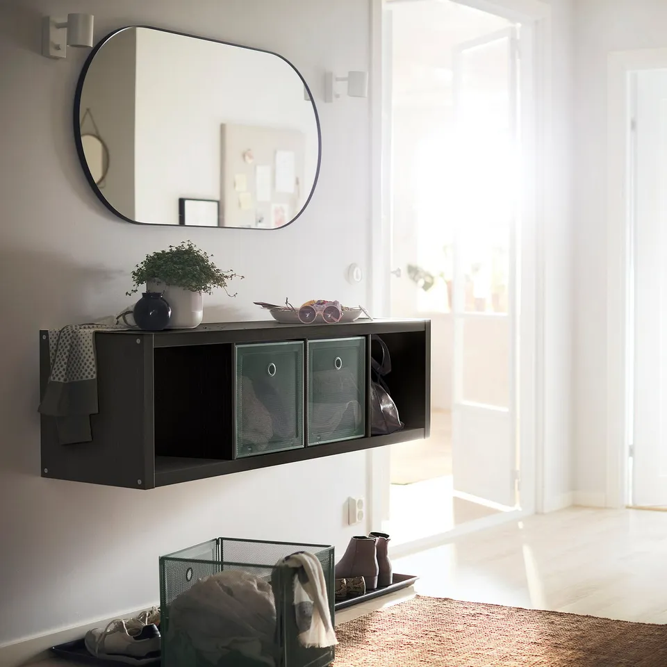 KALLAX shelving with mesh compartments, mirror, plant, coat.
