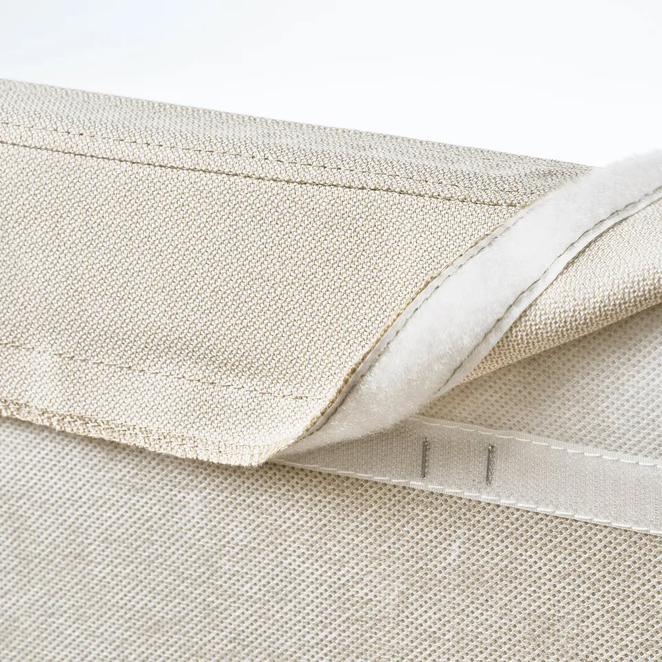 Folded soft upholstered bed frame showing zip detail, highlighting removable and machine-washable cover.