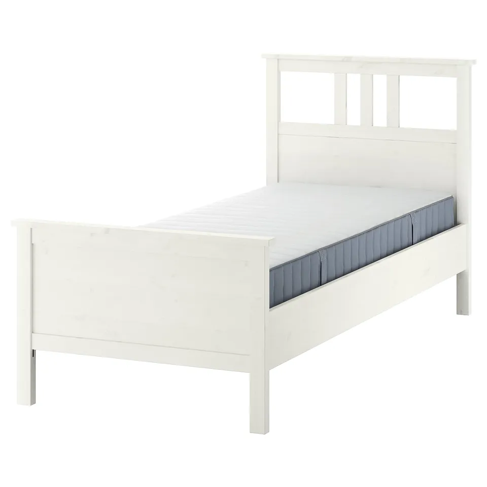 White HEMNES bed, clean design with panelled headboard and footboard, made from solid pine.