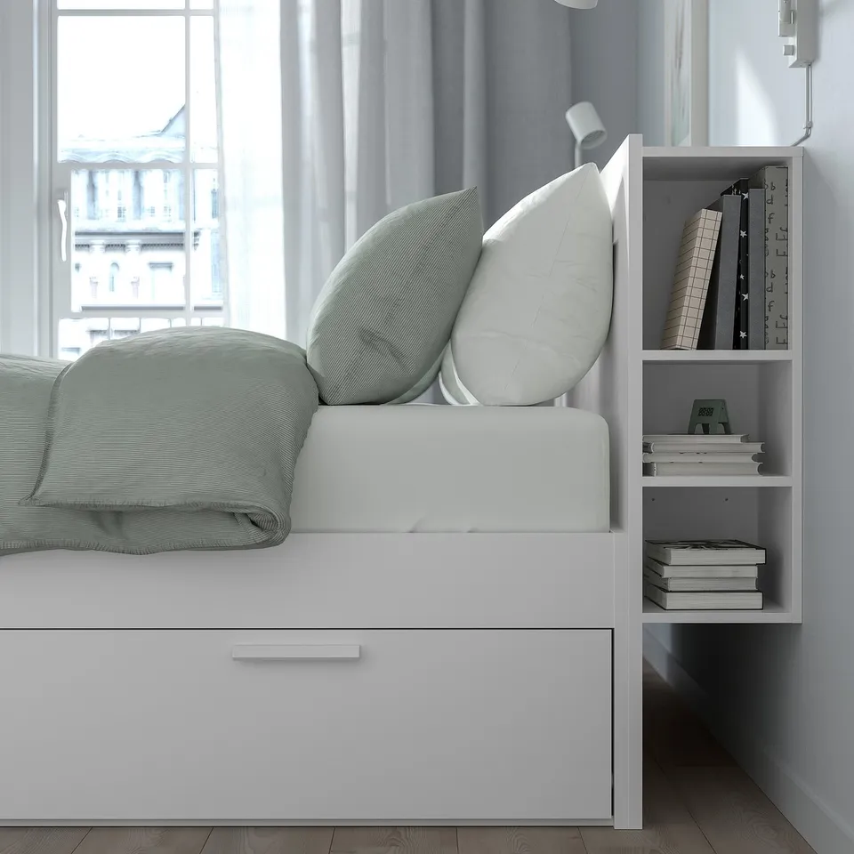 Bed with built-in storage drawers and headboard shelves for space efficiency and organisation.