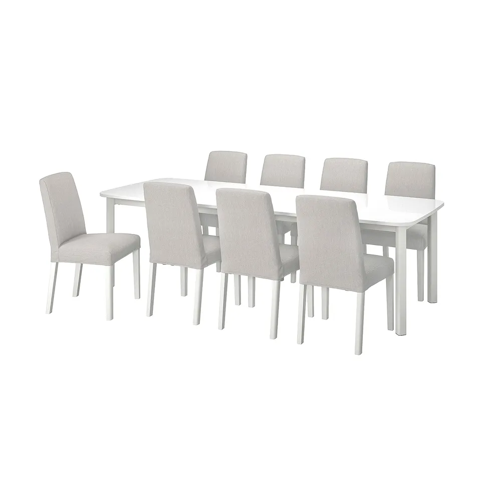 White rectangular dining table with 8 light grey fabric chairs; modern, clean design.