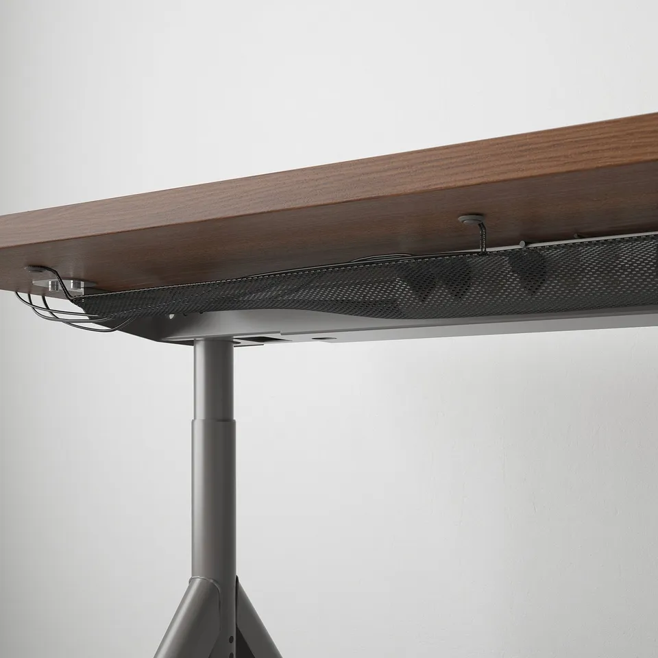 A sturdy desk with a wooden top and a metal frame, featuring a cable management net underneath.