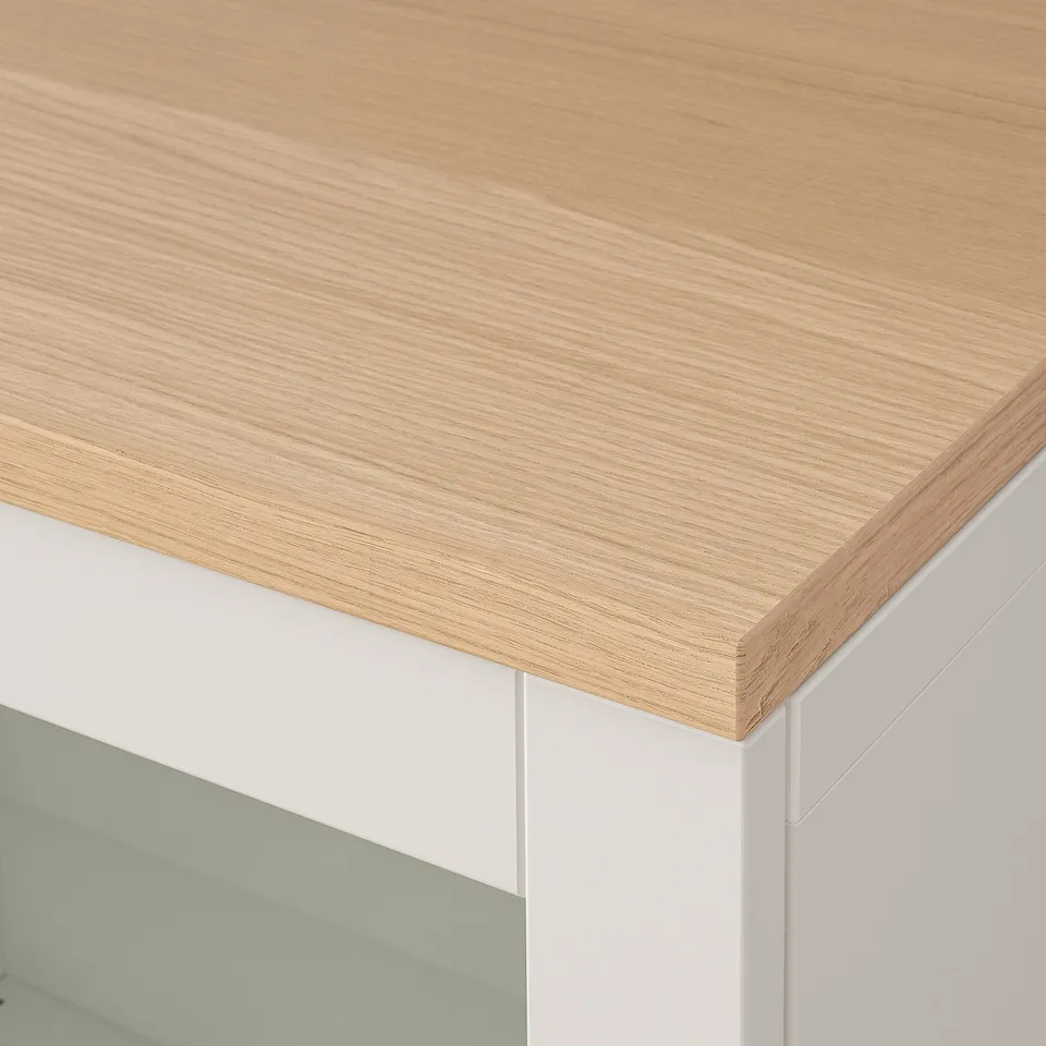 Modern white cabinet with sleek wooden top; smooth finish; minimalist design.