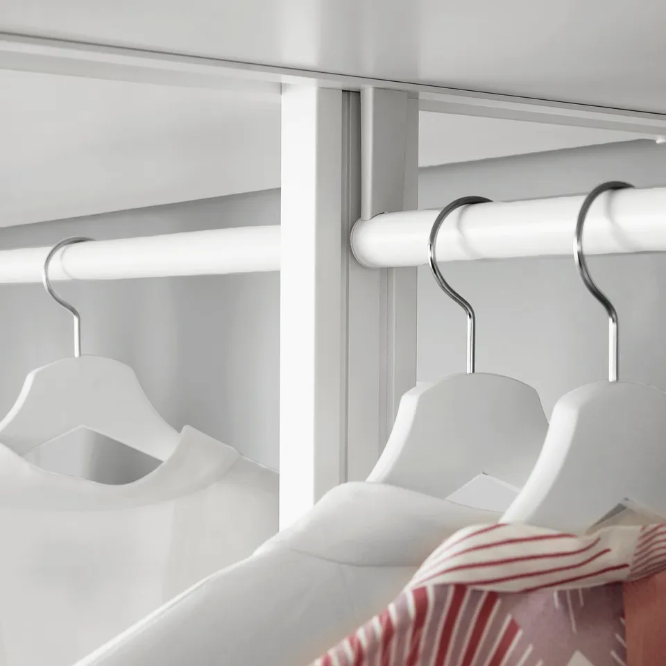 Closet with adjustable clothes rail and hangers.