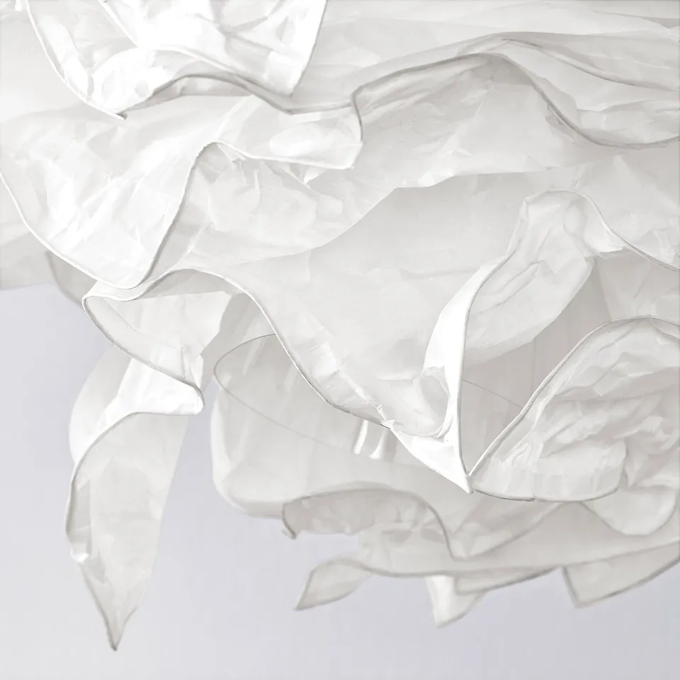 Softly crumbled white paper pendant lamp, emitting gentle, dispersed light. Unique, textured design creates a cosy ambiance.