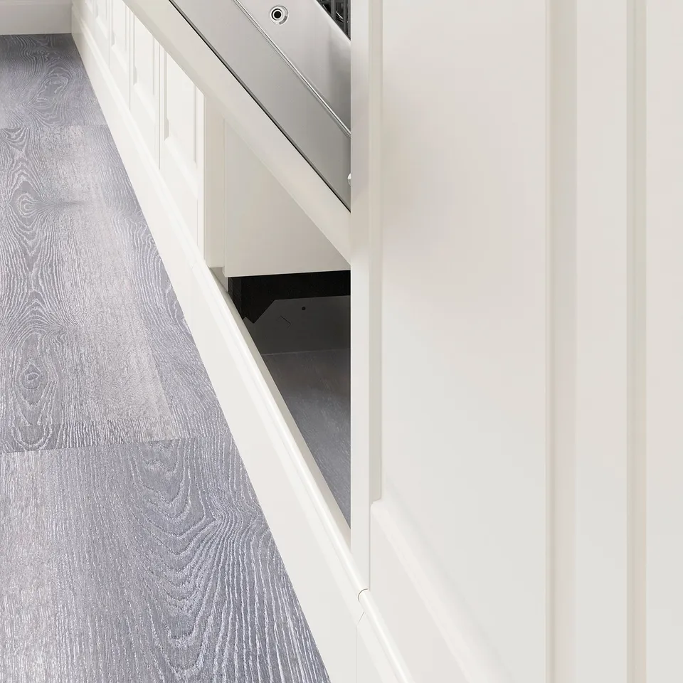 Image shows a kitchen plinth installed under cabinets, covering floor gap, enhancing design.