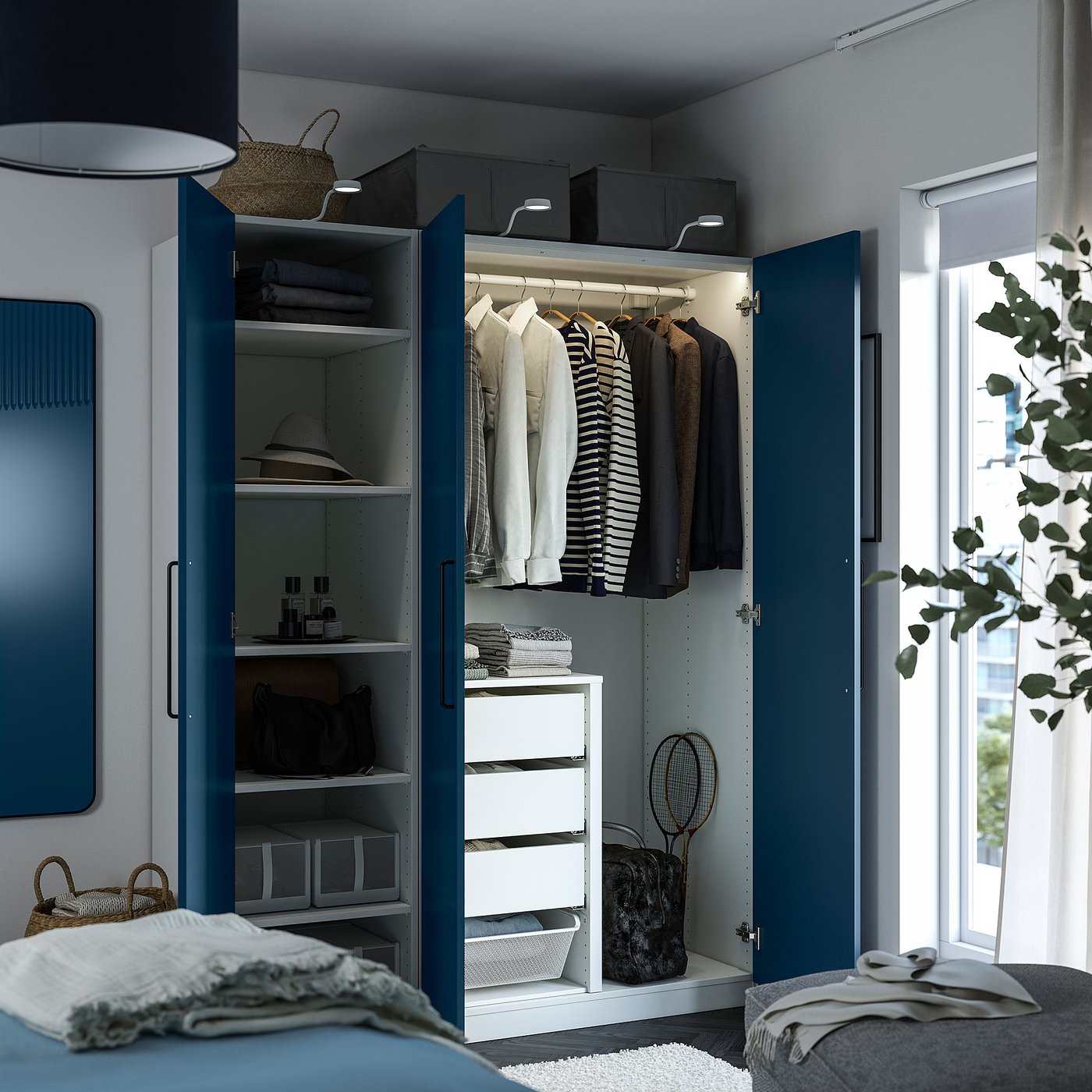 Blue PAX wardrobe, open showing clothes, shelves, drawers, and interior storage boxes.