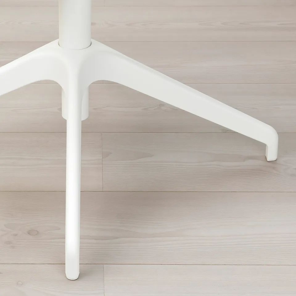 Chair leg detail, refined design, sturdy build, smooth white finish.
