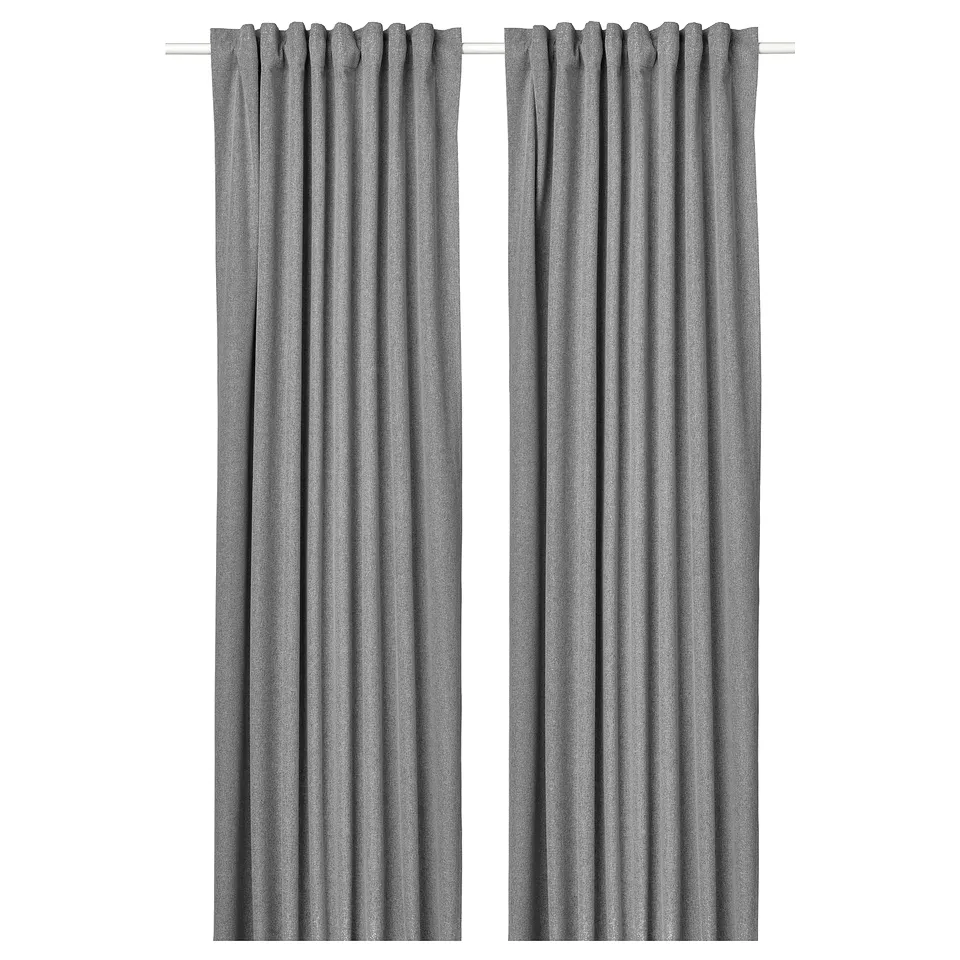 Two grey curtains hang side by side, featuring a streamlined design with rod pockets at the top.