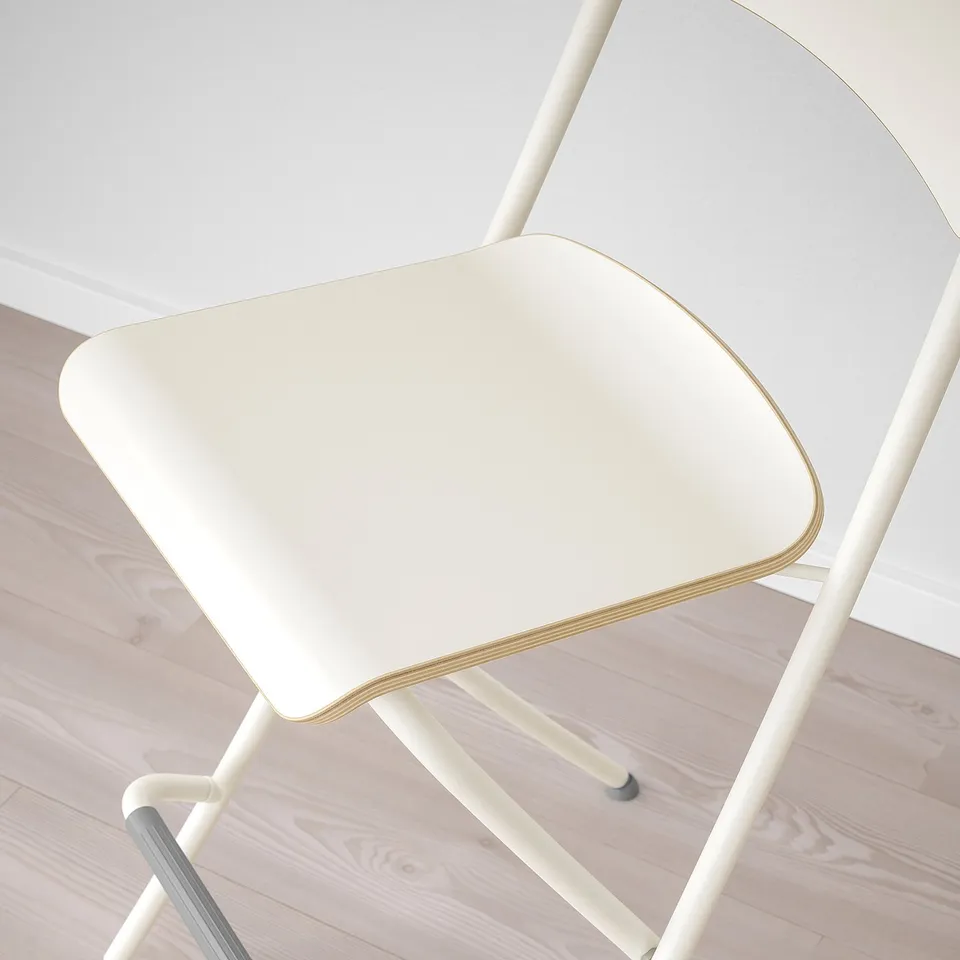 Top view of a white chair with curved edges and metallic legs, indicating modern and sturdy design.