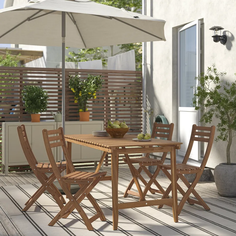 ASKHOLMEN: compact wooden patio set with table & 4 folding chairs. Beige cushions. Coastal styled design, ideal for small spaces.