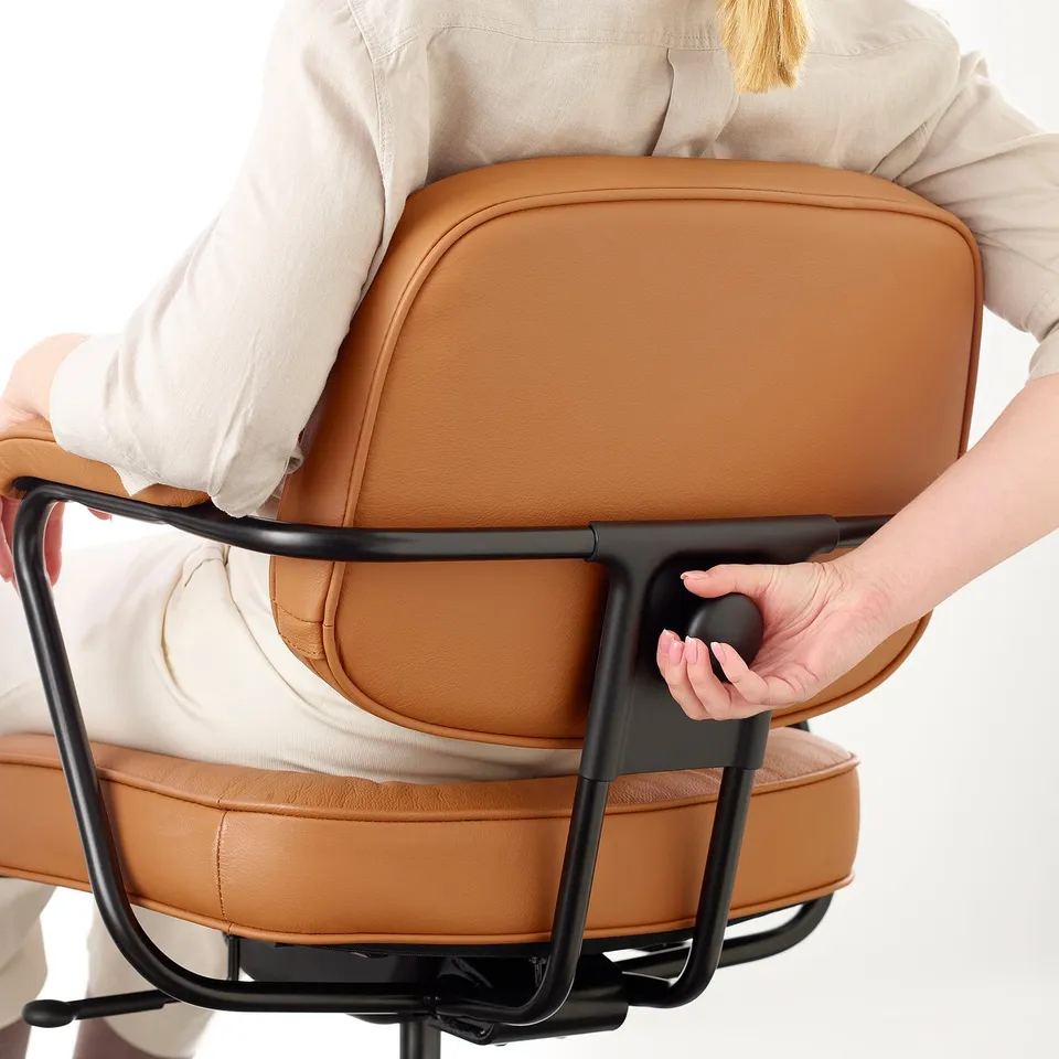 Person adjusting ergonomic office chairs armrest.