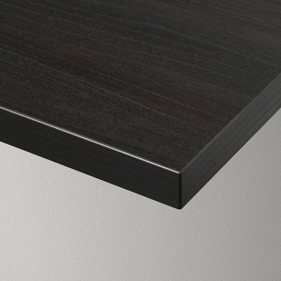 Dark wood grain finish shelf with sleek, bevelled edge resting on a white surface.
