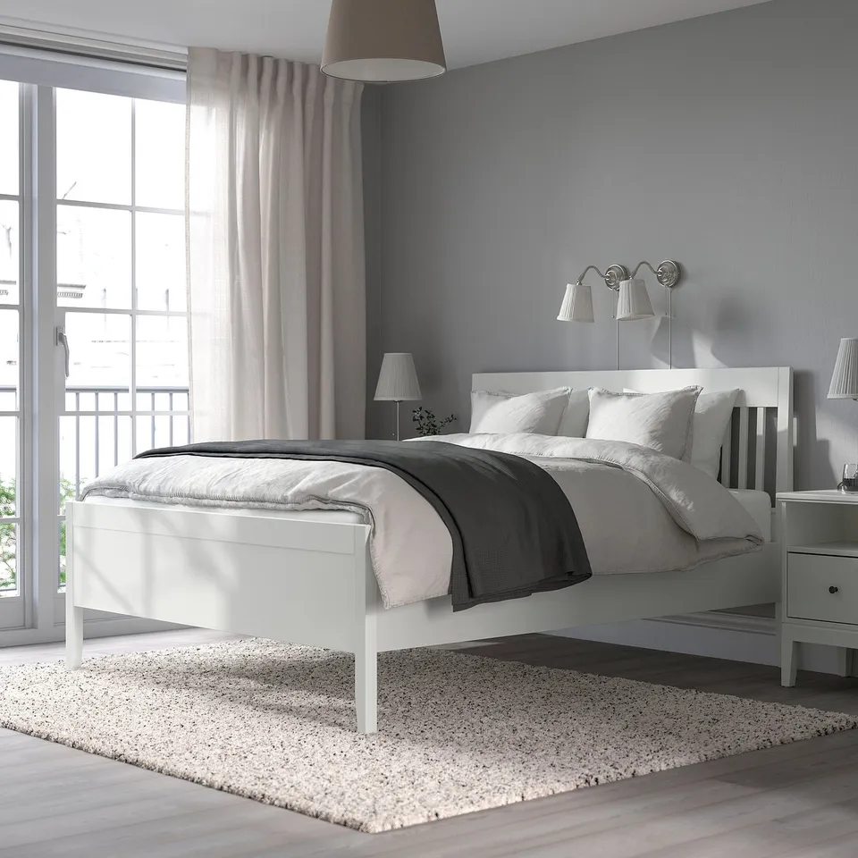 IDANÄS white bed with grey bedding in a serene bedroom setup.