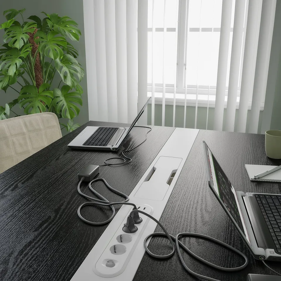 Office table with laptops and cables; includes cable management and power outlets.