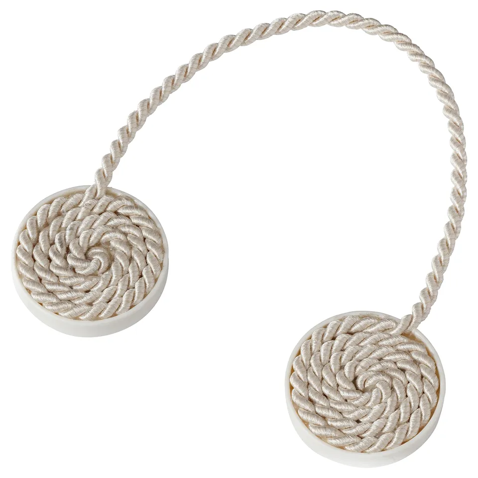 Two white circular magnetic curtain tie-backs with twisted rope design for decorative and practical use.