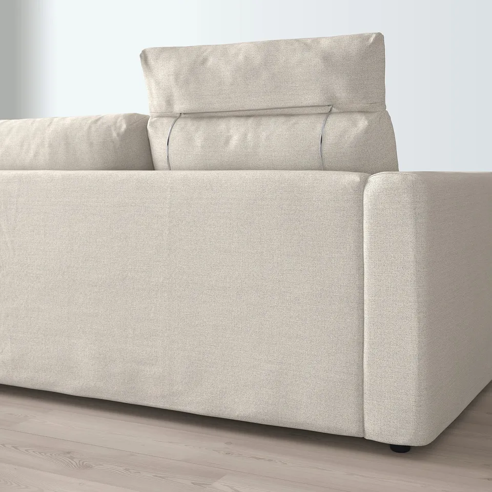 Modern beige sectional sofa with adjustable headrest on light wood floor.