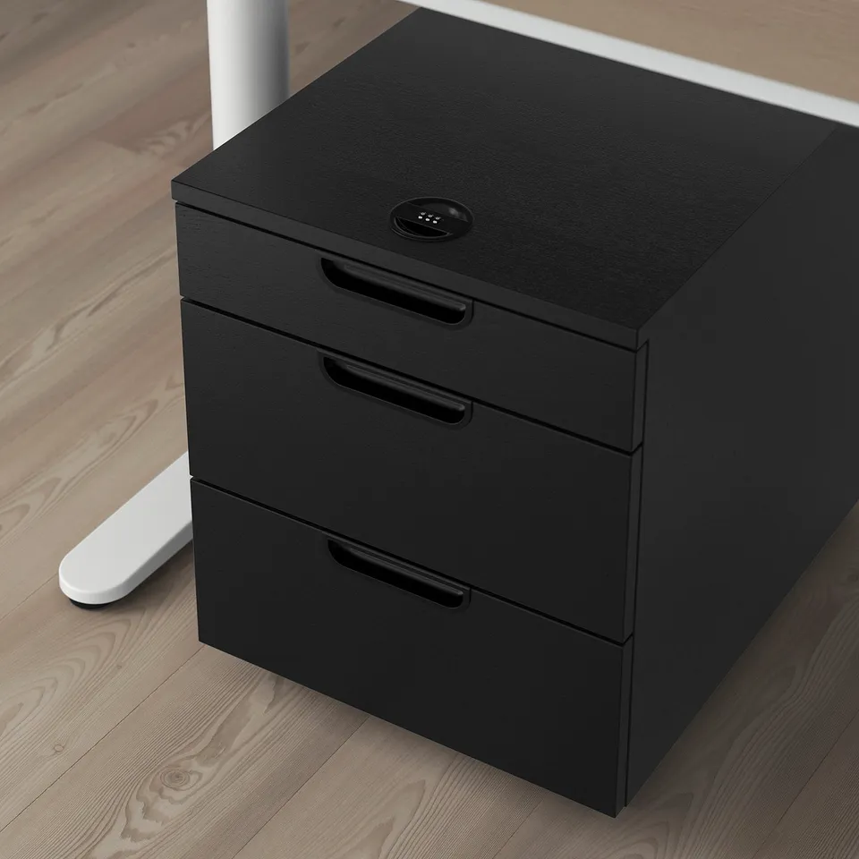 Black office drawer unit with lock and castors for easy movement. Three drawers, top drawer locked.