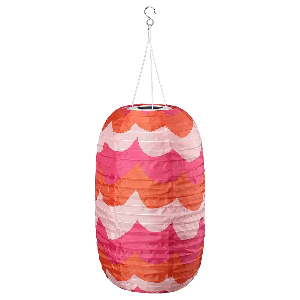 SOLVINDEN solar lantern, colourful waves, hangs by string, emits soft light.