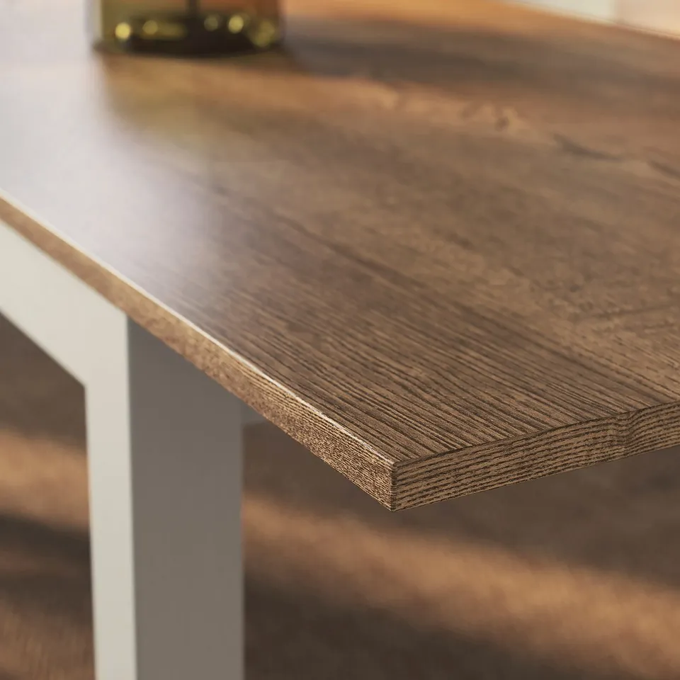 Wooden table with smooth, polished surface and visible grain pattern.