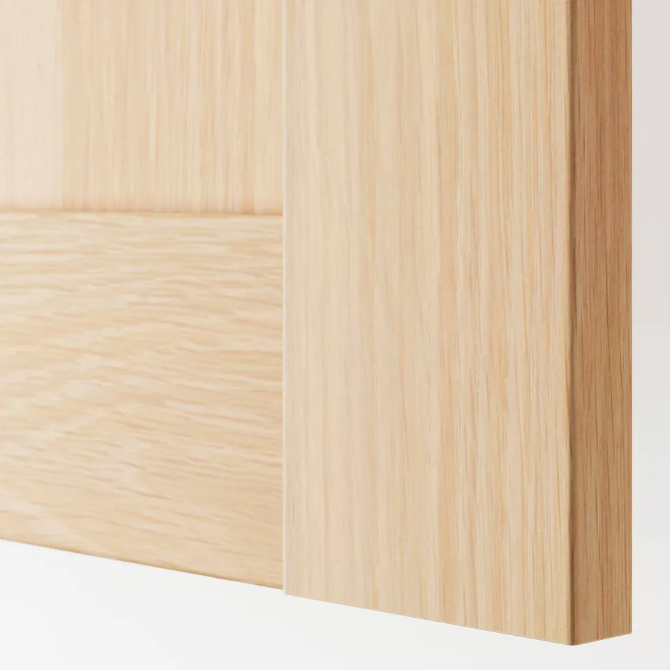Close-up of a light wooden panel door with a sleek, modern finish and smooth grain texture.