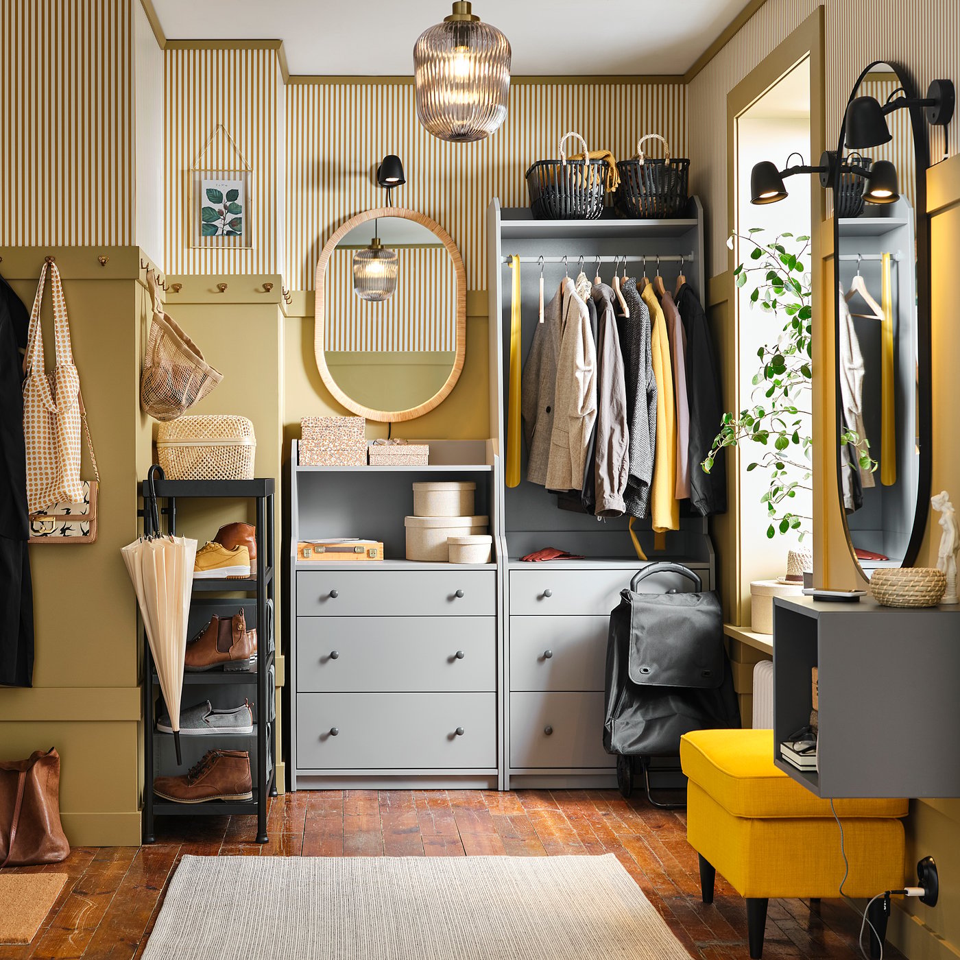 Organised closet with grey HAUGA drawers, yellow accents, hanging clothes, mirror, and wall hooks.
