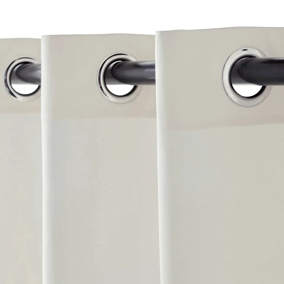 A pair of light-blocking curtains, with eyelets for rod hanging, providing privacy and temperature control.