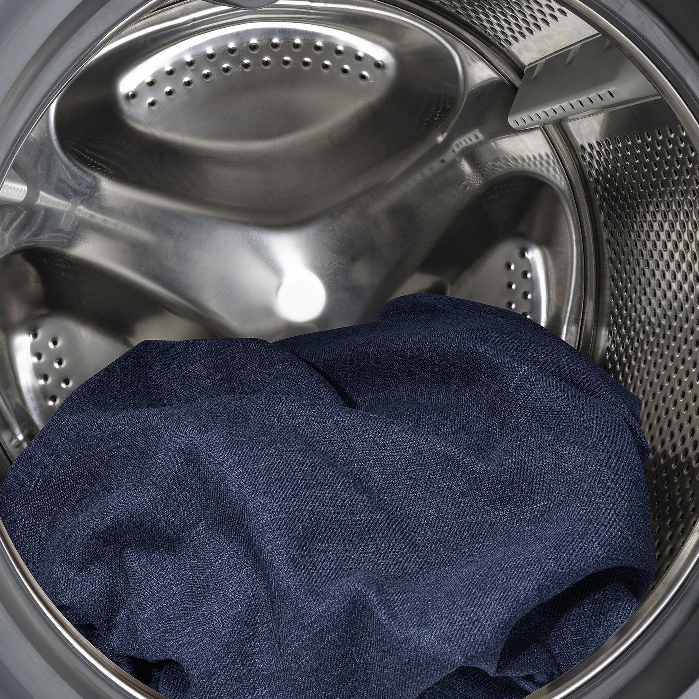 Washing machine interior with dark fabric inside, showing machine-washable feature.