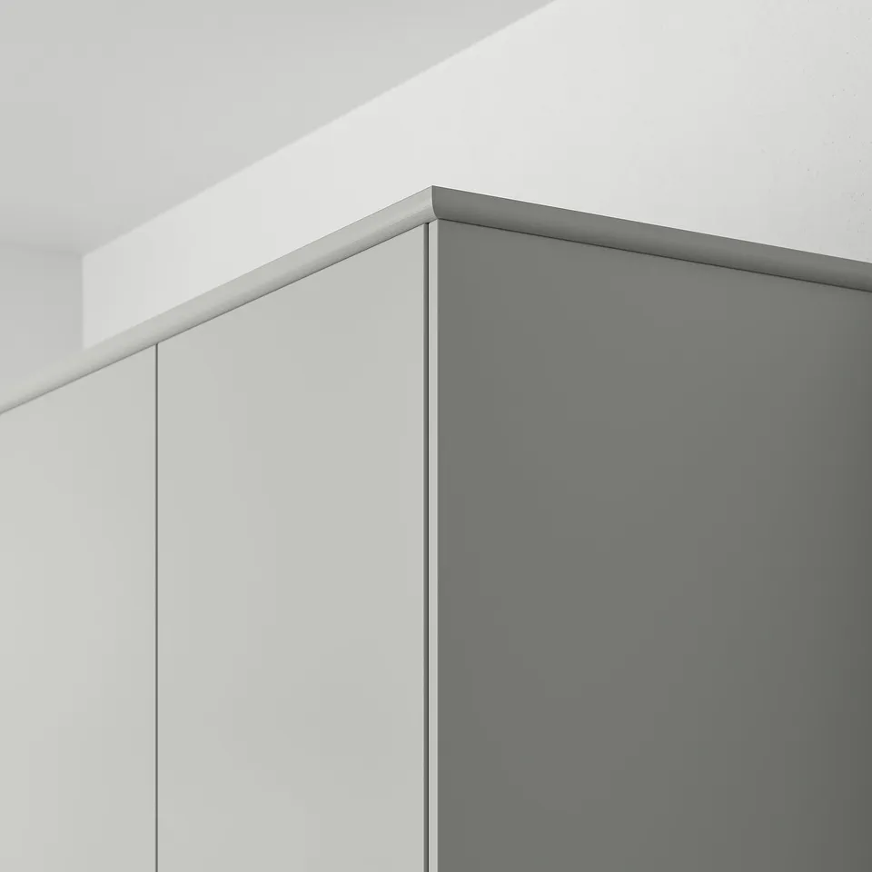 L-shaped light grey kitchen cabinet with hidden lighting.
