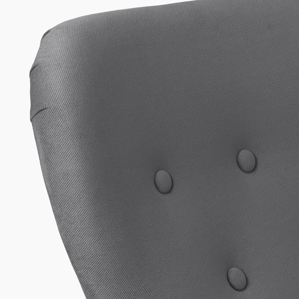 Close-up of grey upholstered chairs back, showing soft fabric and stitching detail.