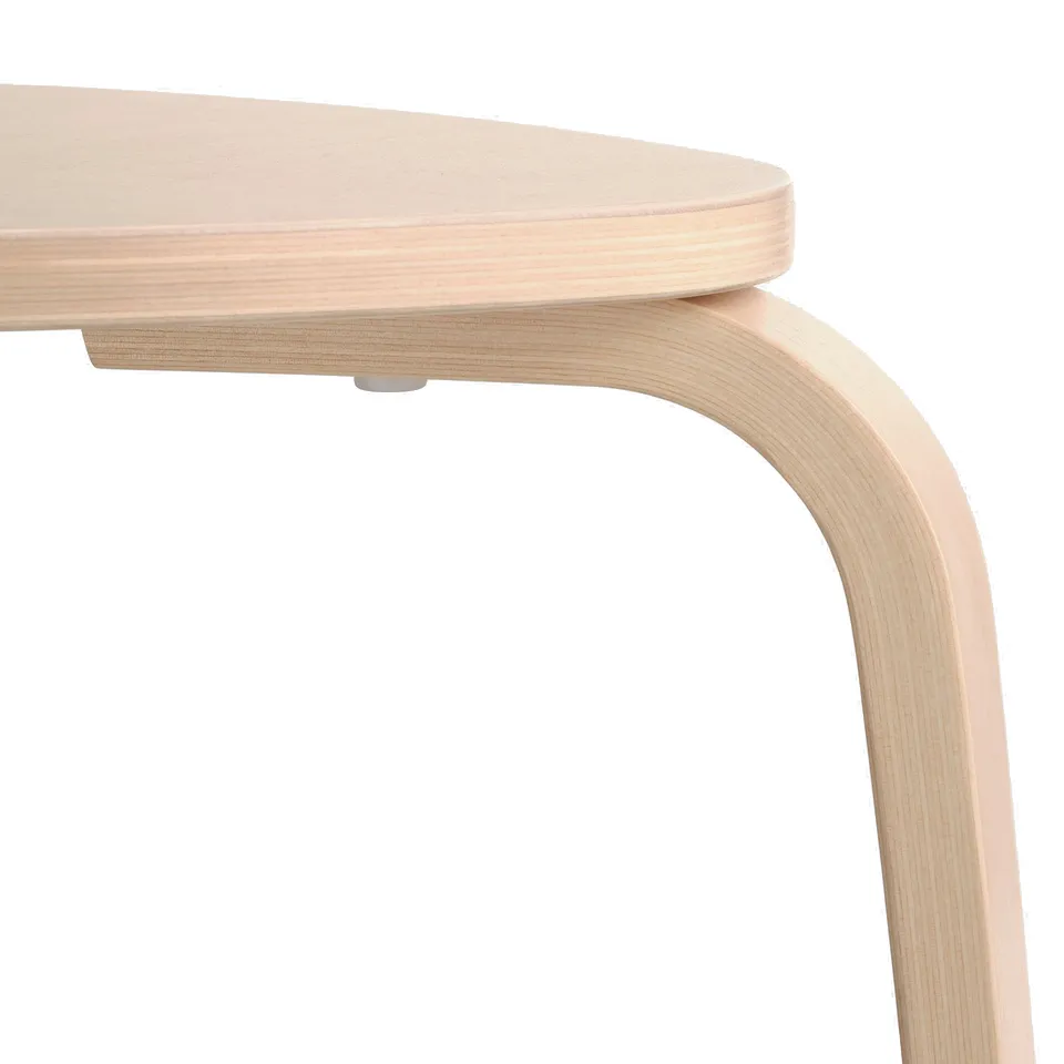 Minimalist stool with smooth birchwood seat and curved legs; high-quality finish.