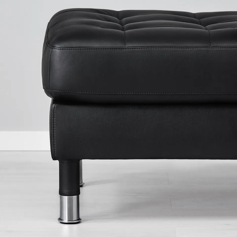 Black leather ottoman with chrome legs. Soft, smooth, high-quality upholstery. Designed for comfort and durability.
