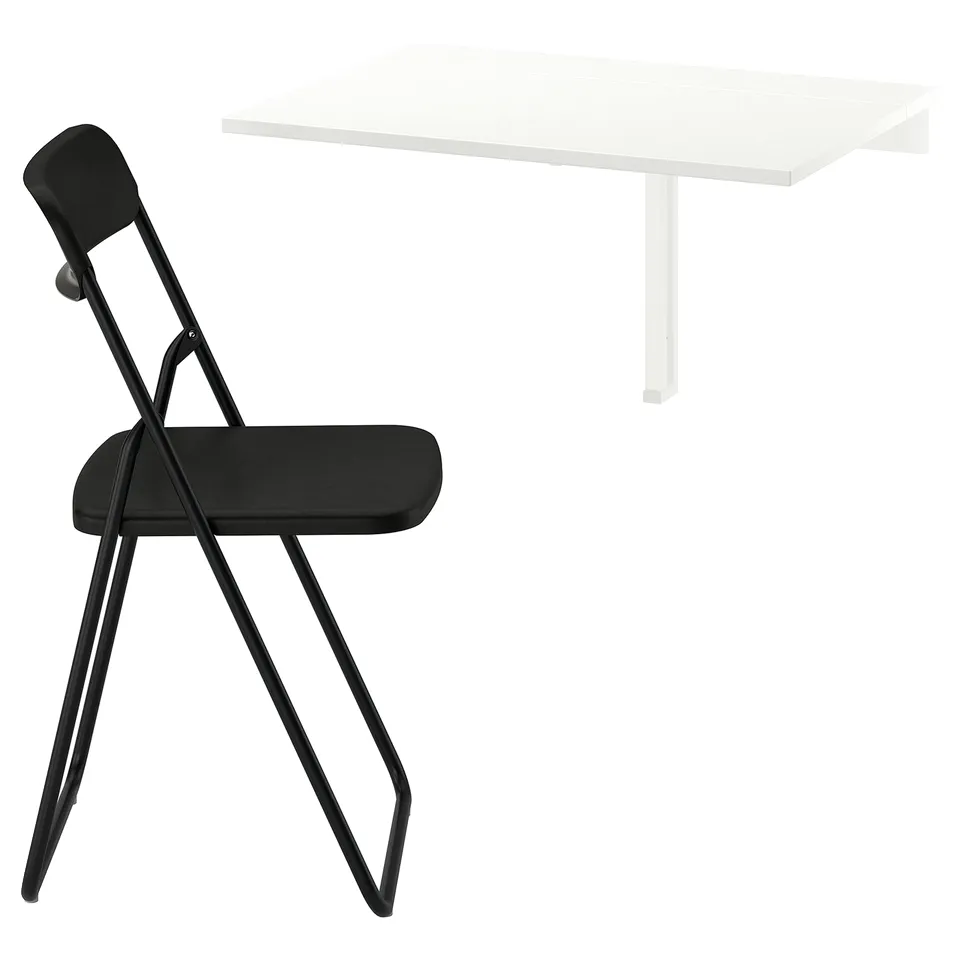 Black folding chair and white wall-mounted desk. Minimalist and modern design for compact spaces.