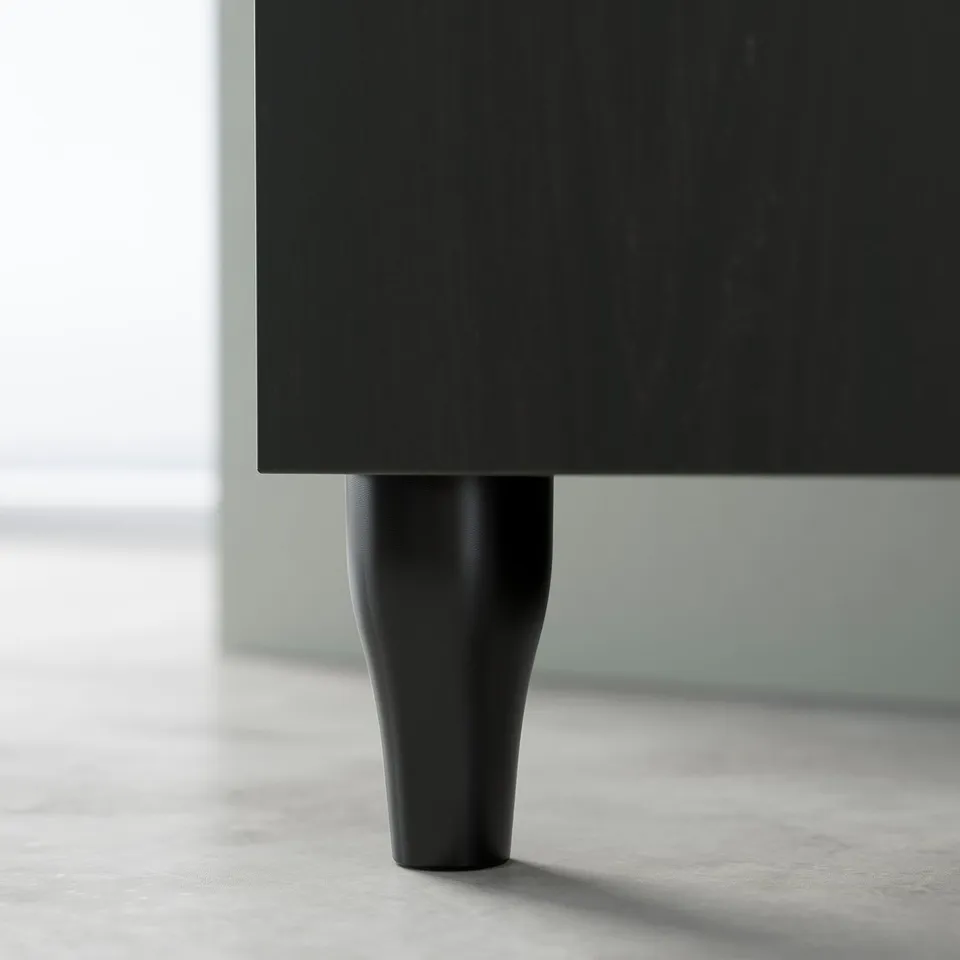 Black wooden furniture leg, slightly tapered and curved, part of IKEAs KABBARP series, enhancing traditional storage solutions.