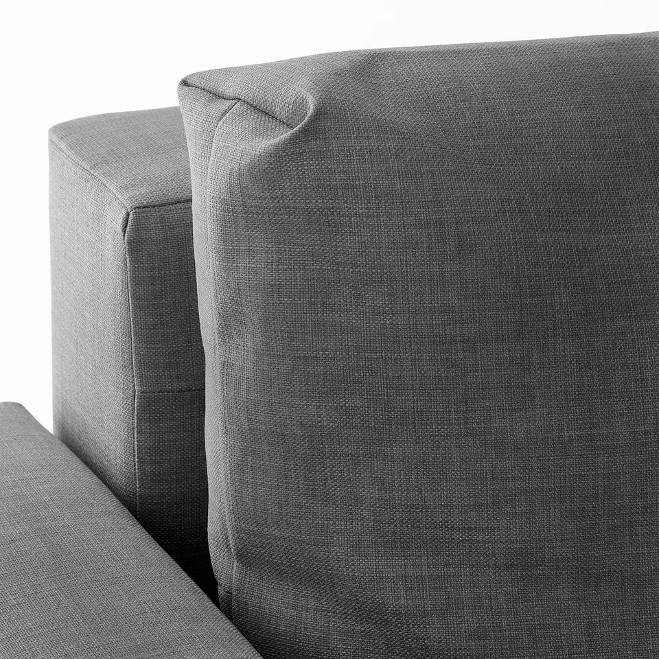 Modern sofas plush, textured grey fabric. Angled shot highlights soft, inviting backrest and seat.