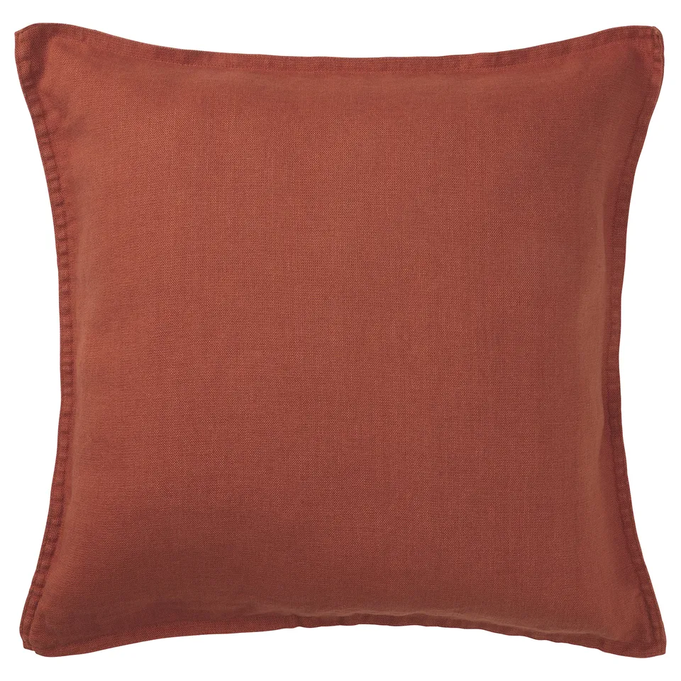 Square burnished red cushion. Made of linen with a soft, textured finish and clean edges.