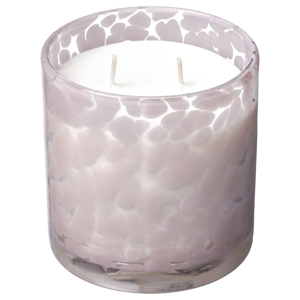 Lavender-colored glass candle with textured design, two wicks, jasmine scent. Handmade, sits upright.