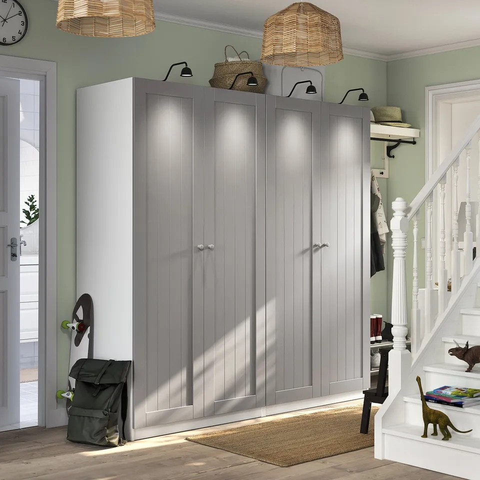 Entryway with tall grey GULLABERG closets, light wood floor, green walls, and soft-close hinges.