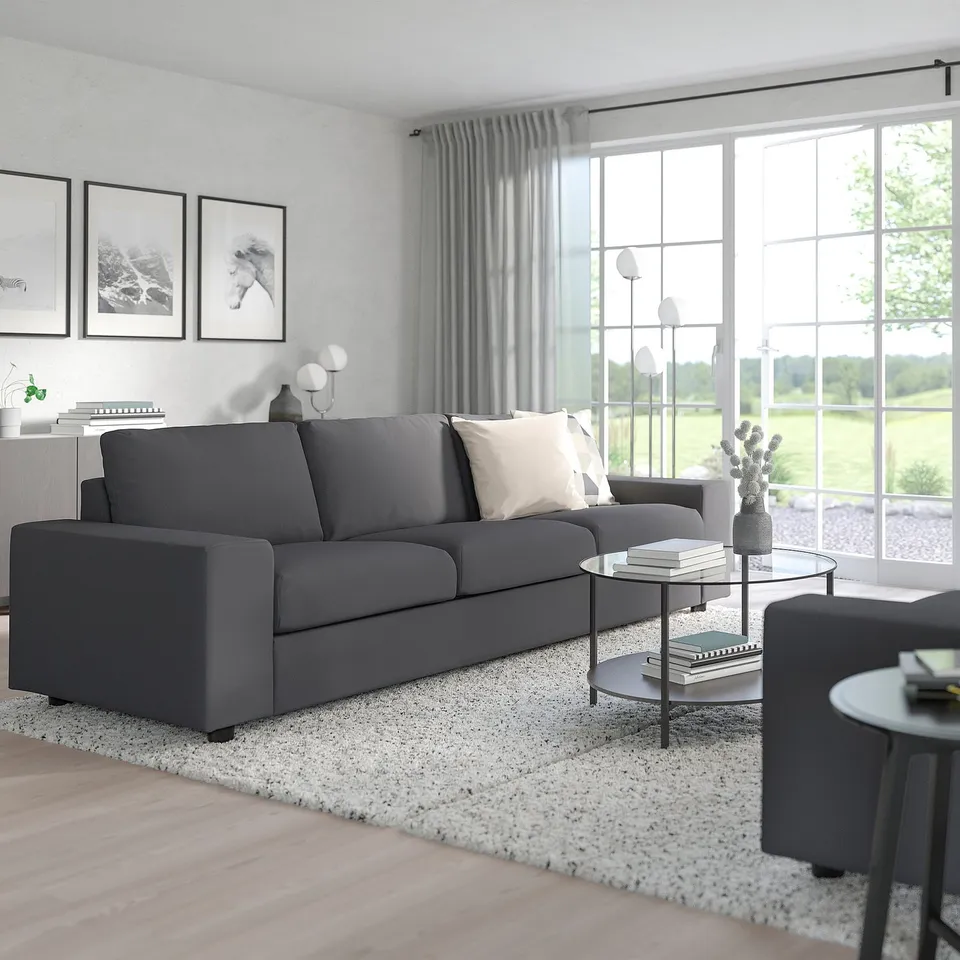 Contemporary living room with VIMLE sofa, curtains, and large windows. Sofa is spacious with dark grey cushions.
