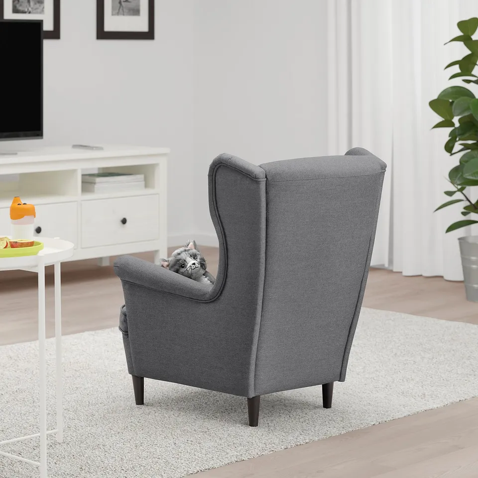 Grey childrens armchair with high back, perfect for relaxation and reading.