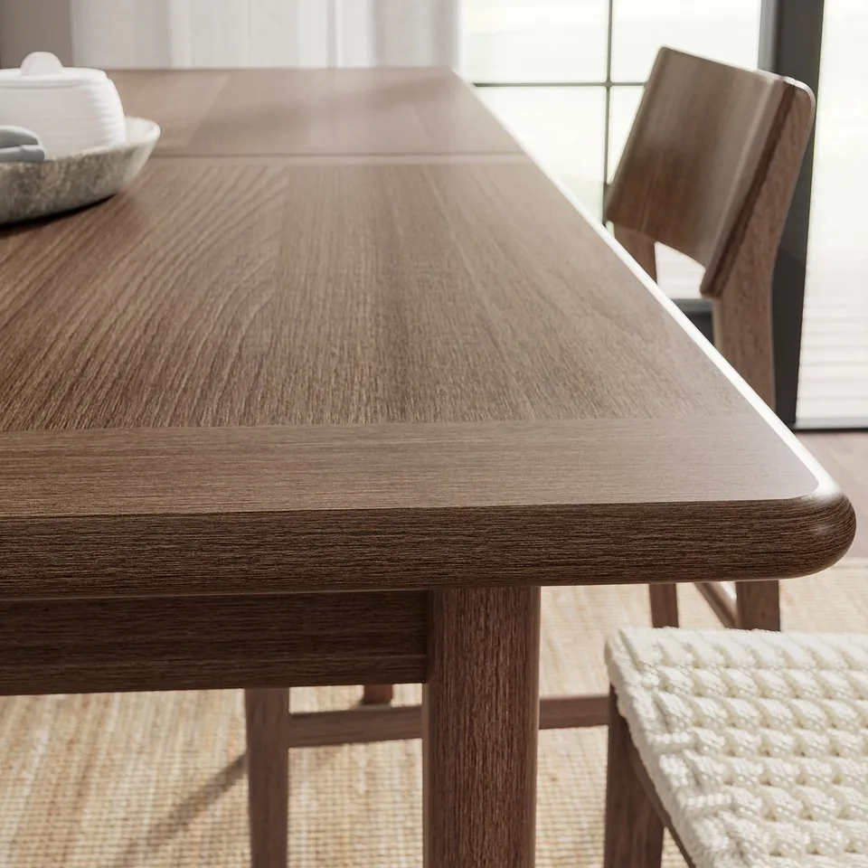 SKANSNÄS: dark brown, rectangular dining table with smooth edges, light reflecting on wooden surface, set for four.